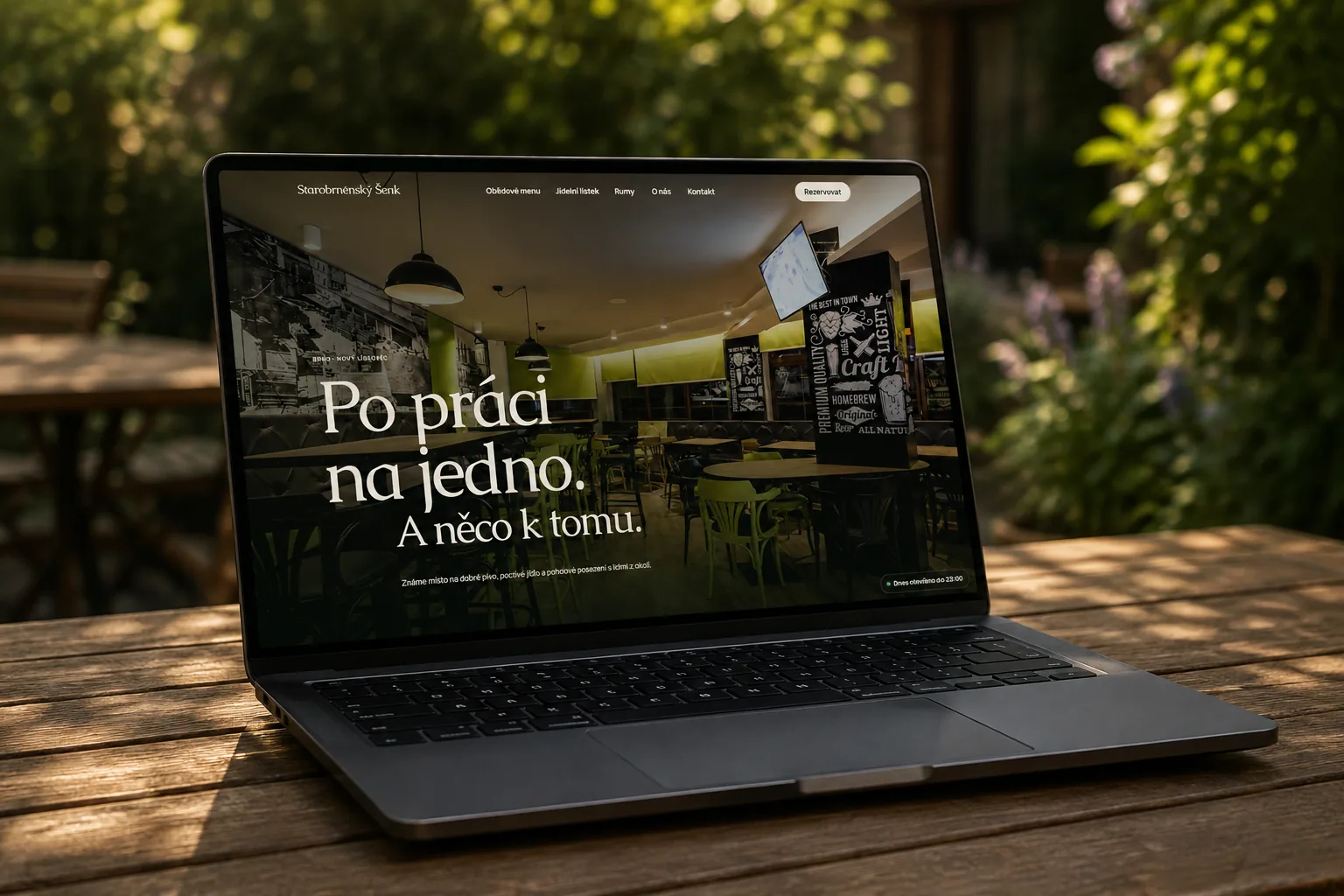 Starobrněnský šenk website shown on a laptop outdoors